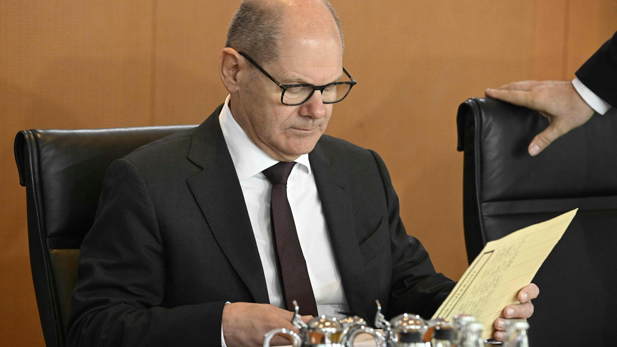 German Chancellor Olaf Scholz looks through documents prior to the weekly meeting of the German cabinet on April 5, 2023 at the Chancellery in Berlin. (Photo by Tobias SCHWARZ / AFP)