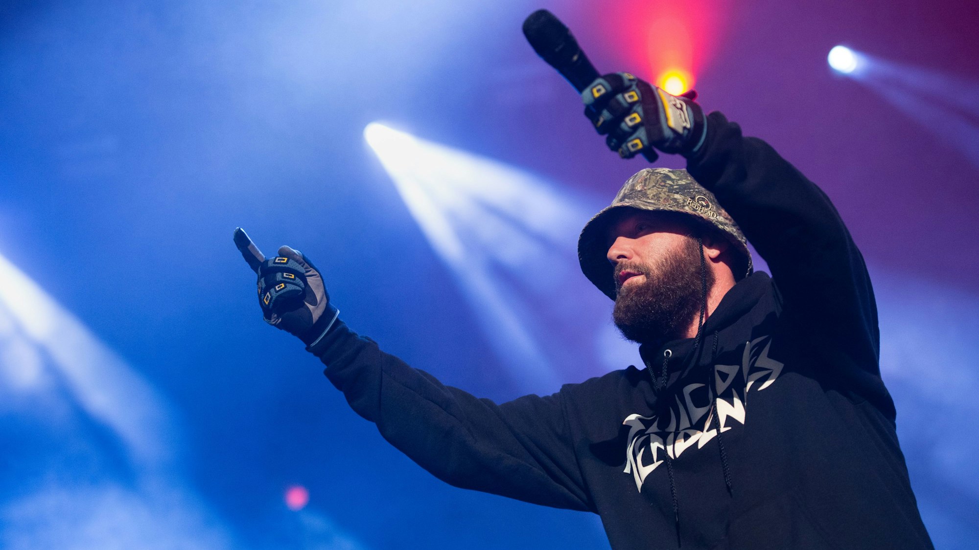 Fred Durst, Frontmann von Limp Bizkit, hält ein Mikrofon in die Menge bei einem Auftritt 2016. Beim Konzert in Frankfurt versagte die Simme des Frontmanns und der Auftritt wurde zur unfreiwilligen Fan-Karaoke. (Archivbild)