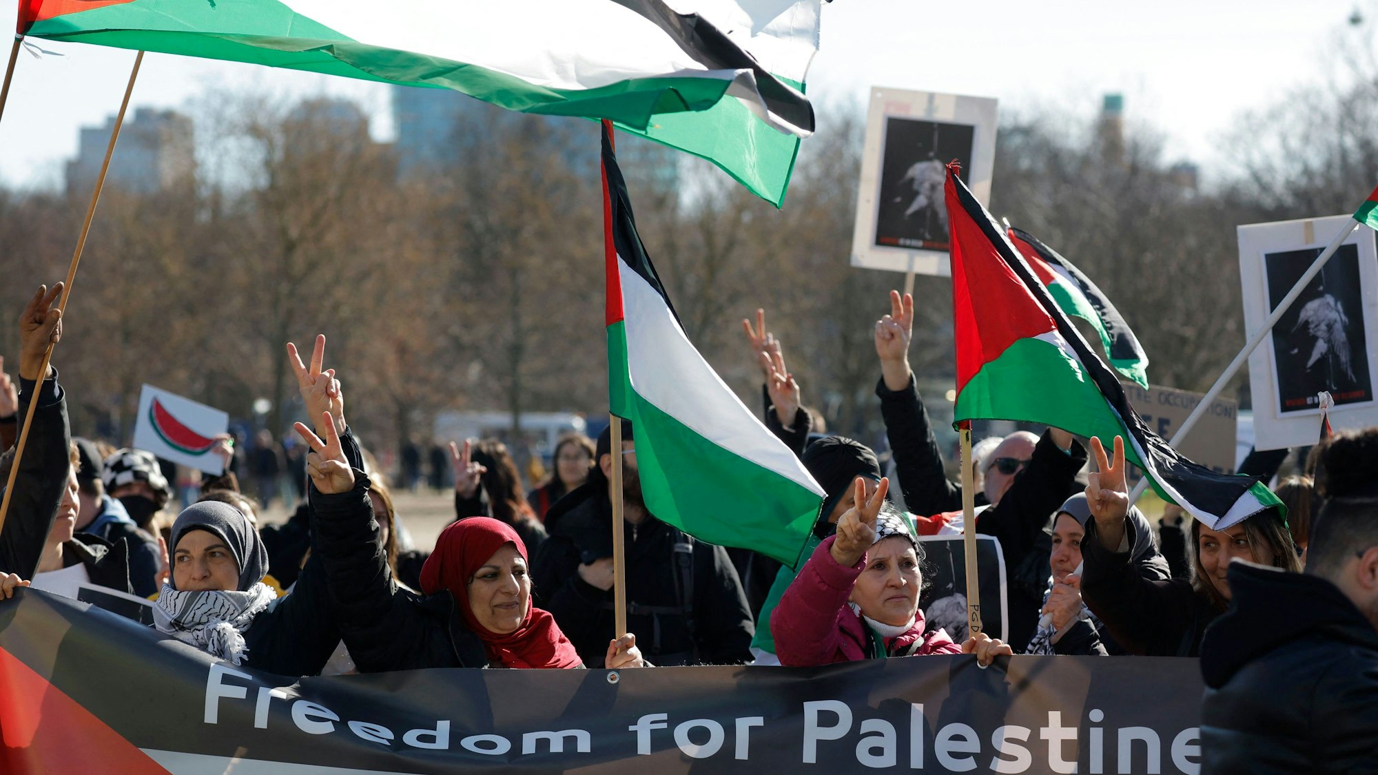 Demonstrators hold flags of Palestine as they protest on March 16, 2023 in front of the Bundestag (lower house of German parliament) in Berlin against the policy of Israeli Prime Minister Benjamin Netanyahu