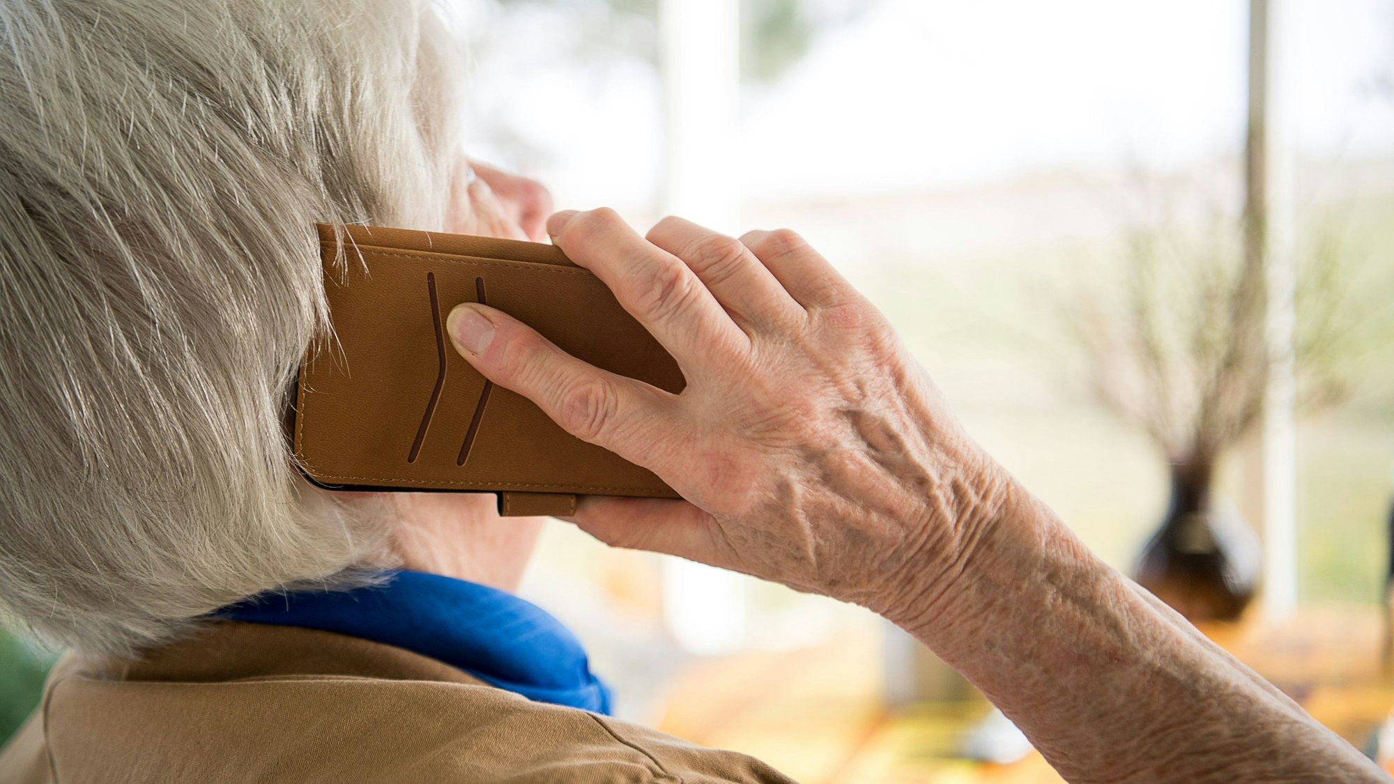 Eine Seniorin telefoniert mit ihrem Smartphone.