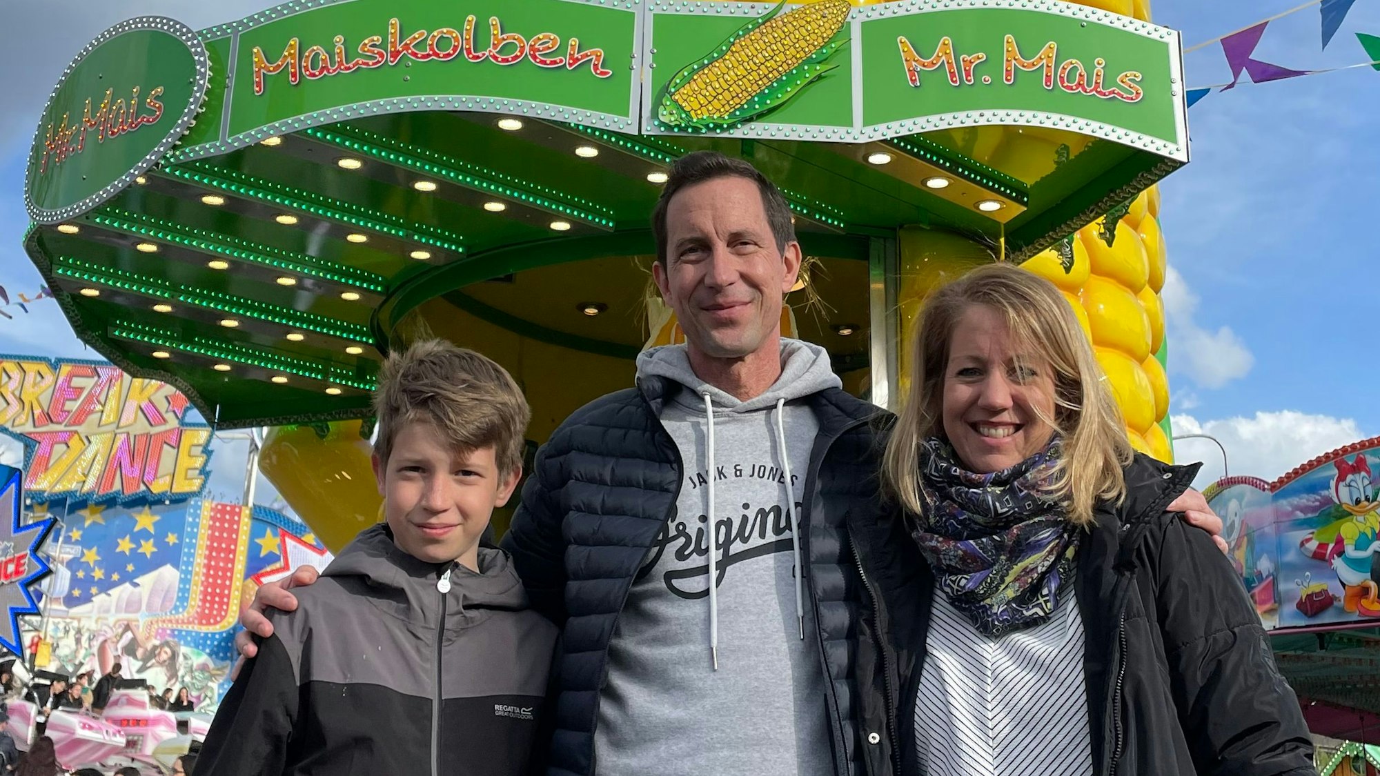 Schon schön! finden Jannik, Michael und Katja B. die Kirmes. Sie stehen vor einem riesigen Maikolben-Verkuafsstand.