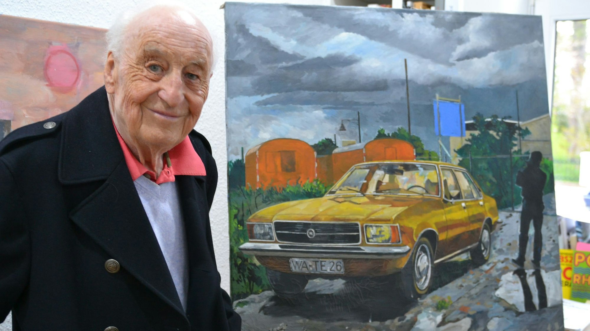 Es ist der Künstler Henning John von Freyend vor einem seiner Werke zu sehen.