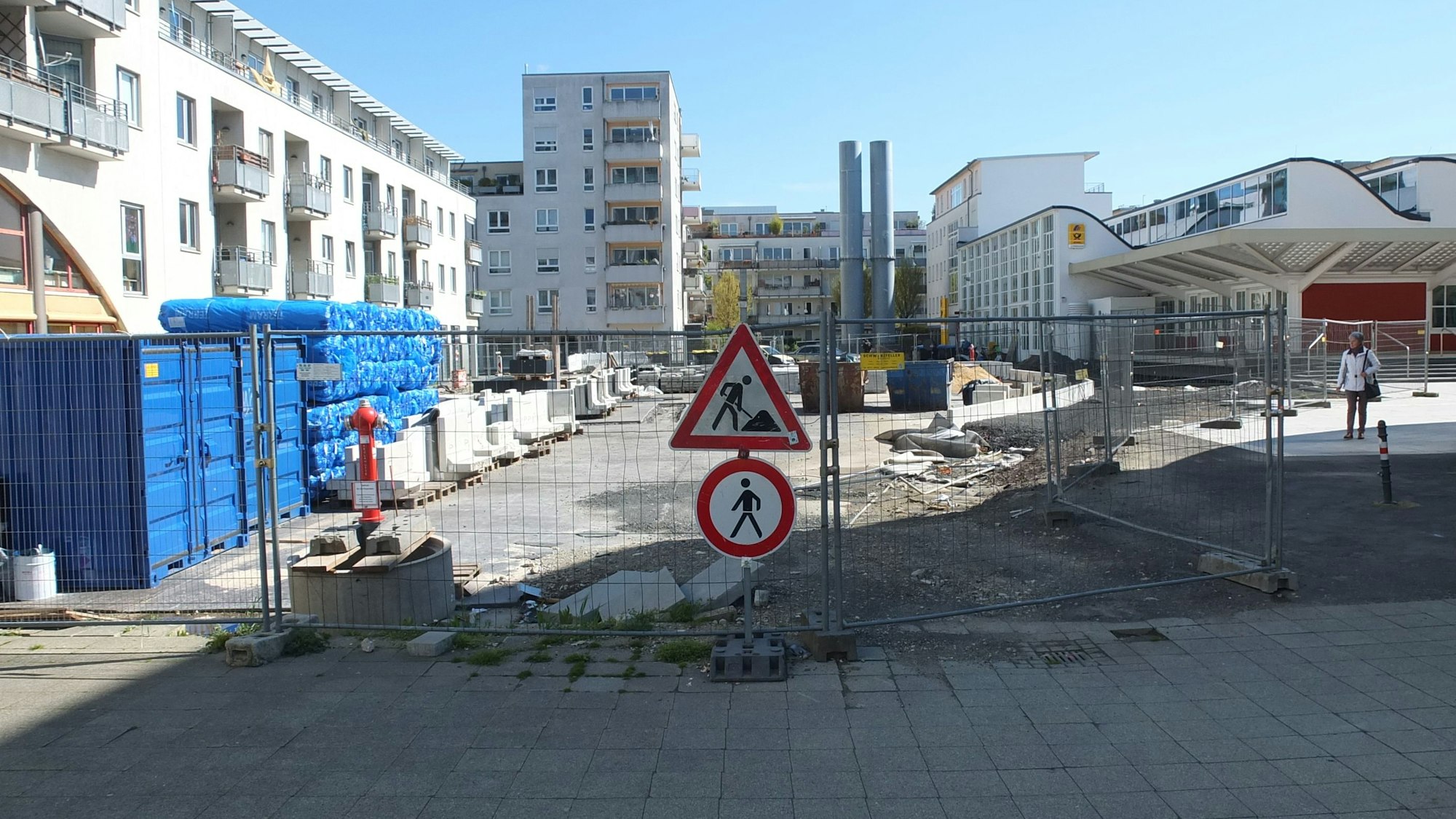 Bauzäune und Baumaterial stehen auf einem umschlossenen Innenhof, der Teil des Kölnisch Quartiers ist.