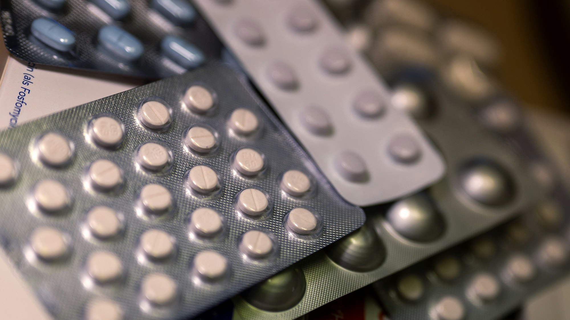 Diverse Medikamentenpackungen liegen auf einem Tisch in einer Apotheke.