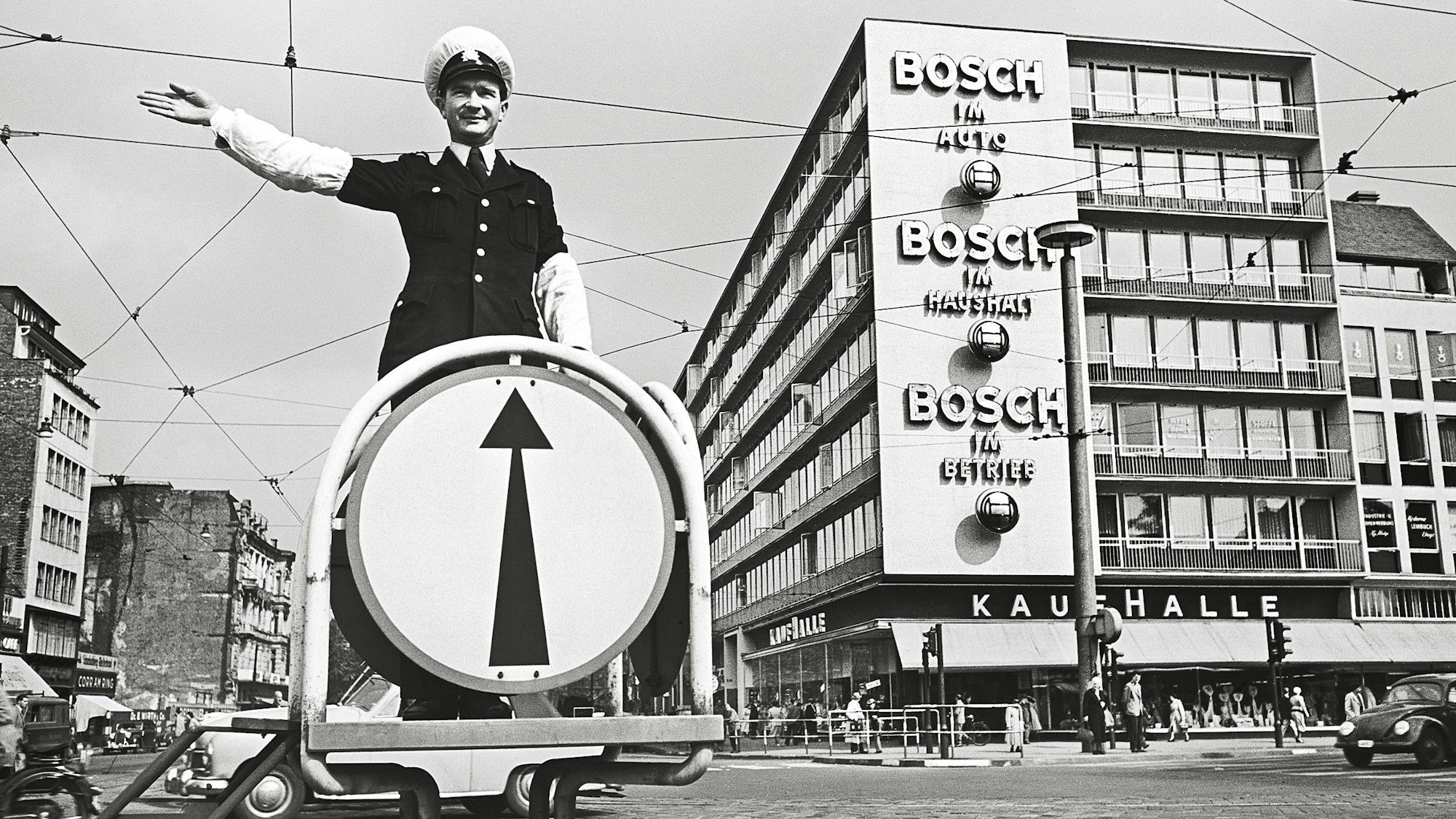 NEin Schutzmann steht auf einer großen Kreuzung.