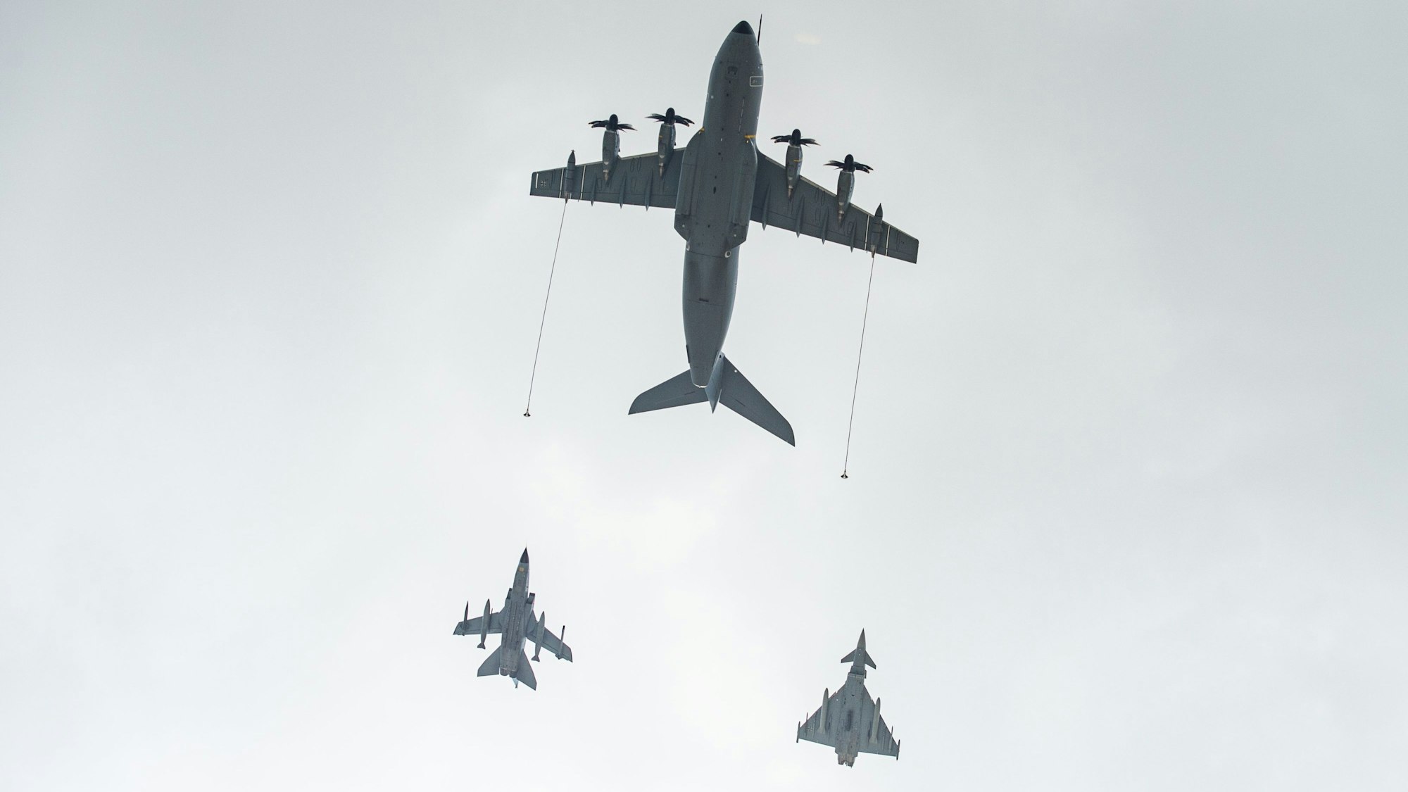 Ein Airbus A400M Transportflugzeug (o) fliegt vor einem Panavia 200 (PA-200) Tornado Mehrzweckkampfflugzeug (l) und einem Eurofighter Typhoon Mehrzweckkampfflugzeug (r) über den Fliegerhorst Wunstorf.