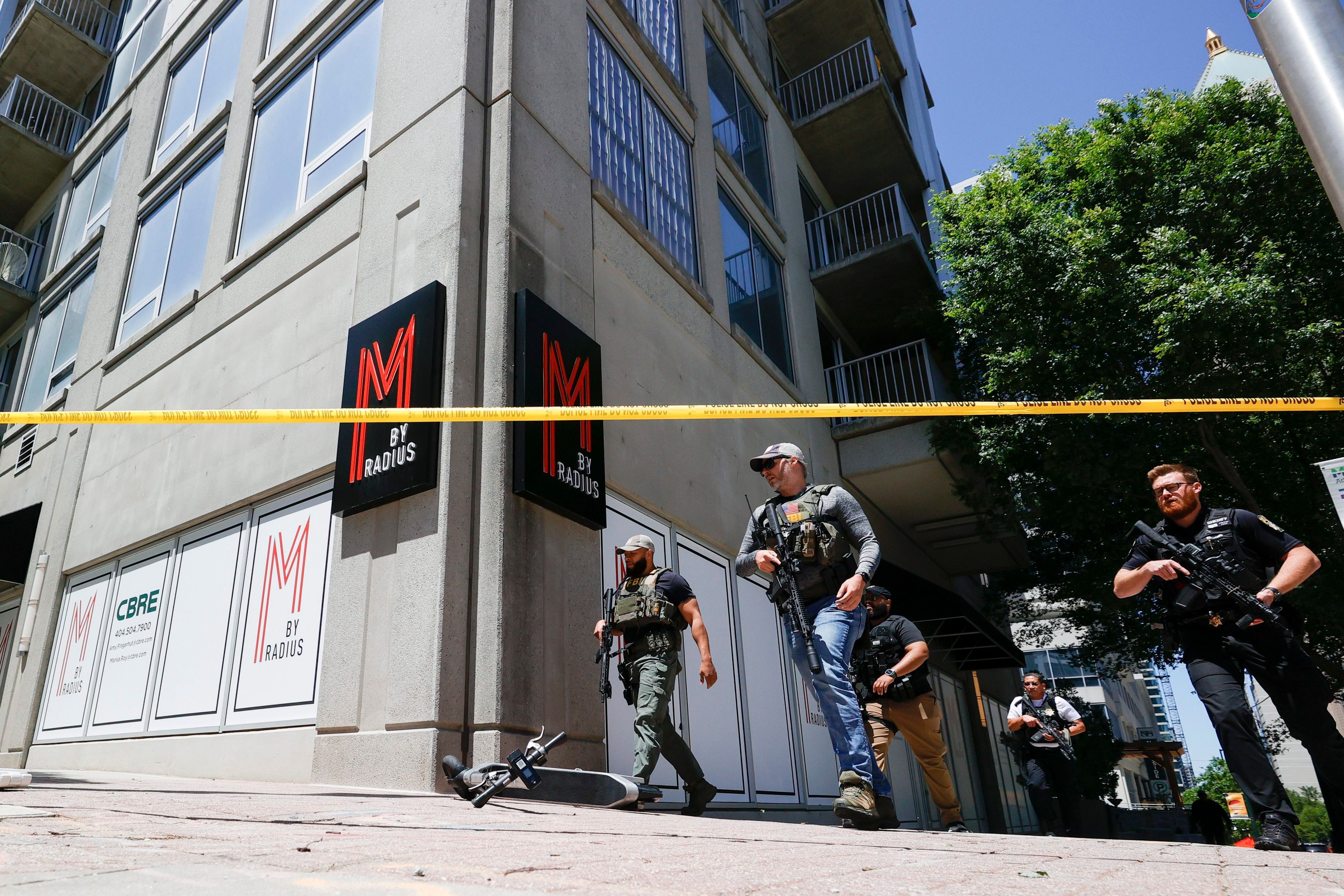 Law enforcement officers arrive near the scene of an active shooter on Wednesday, May 3, 2023 in Atlanta. Atlanta police said there had been no additional shots fired since the initial shooting unfolded inside a building in a commercial area with many office towers and high-rise apartments.  (AP Photo/Alex Slitz)