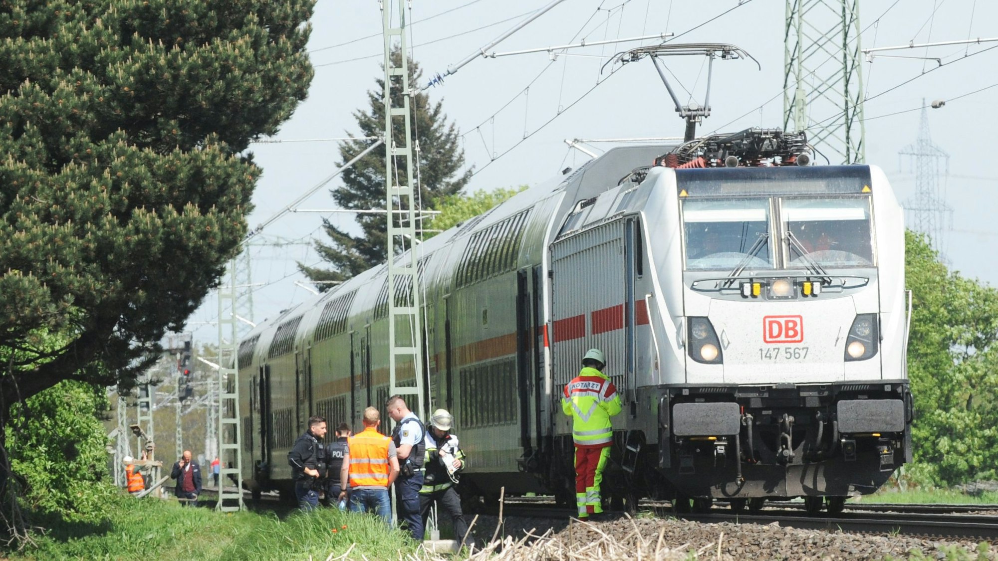 Ein Intercity steht auf den Gleisen. Mehrere Personen stehen daneben.