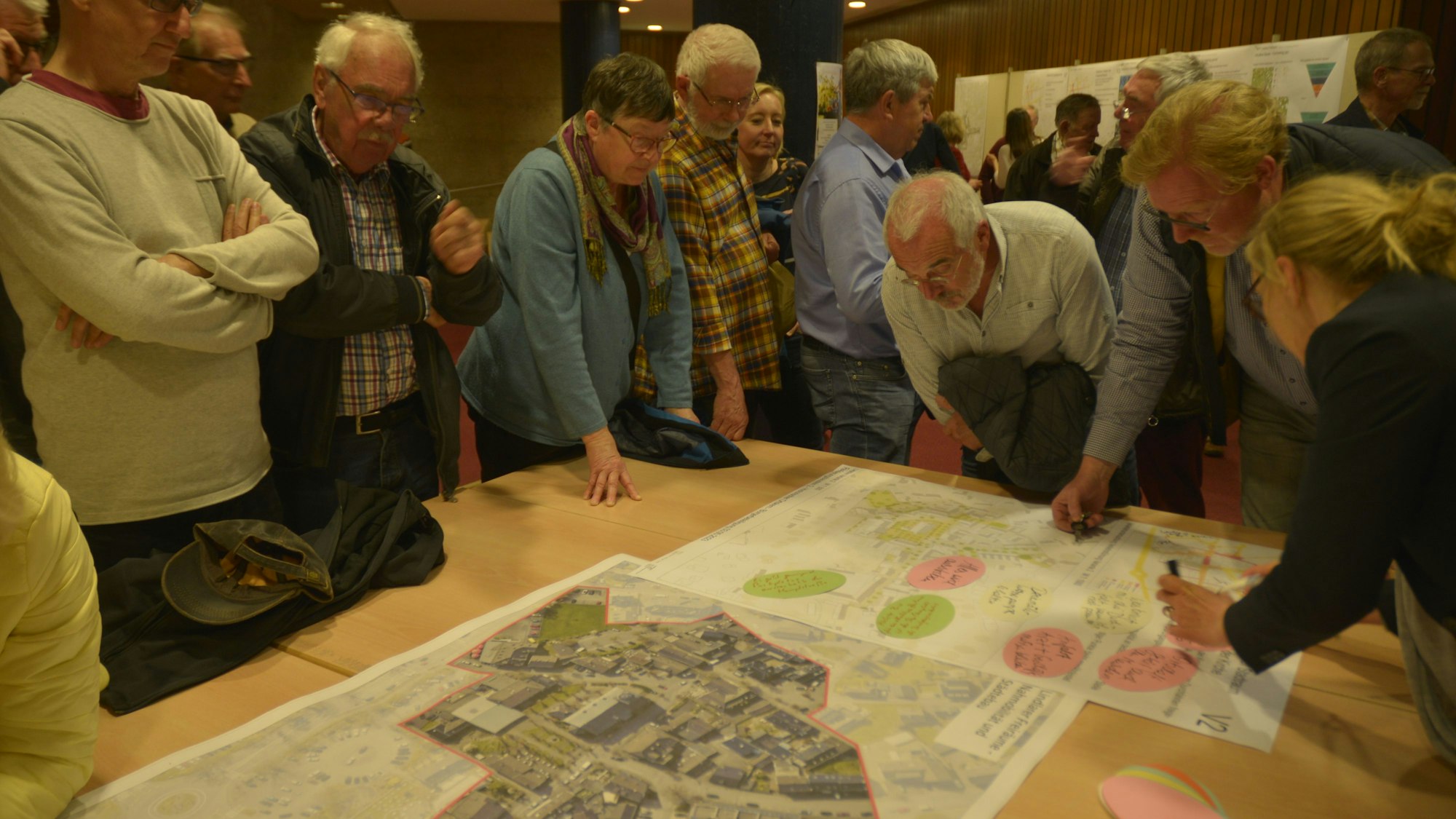 Bürger beraten bei der Bürgerbeteiligung zum Stadtentwicklungsprogramm Isek in einem Workshop über Pläne.