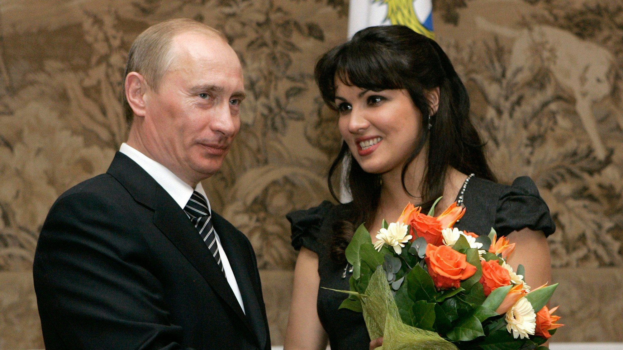 FILE - Russian President Vladimir Putin, left, congratulates Russian opera singer Anna Netrebko after awarding her with the People's Artist of Russia honor, during the 225th anniversary celebrations of the Mariinsky Theater in St. Petersburg, Russia, on Feb. 27, 2008. Netrekbo withdrew from her future engagement at the Metropolitan Opera rather than repudiate her support for Russia President Vladimir Putin, costing the company one of its top singers and best box-office draws. (AP Photo/Dmitry Lovetsky, File)