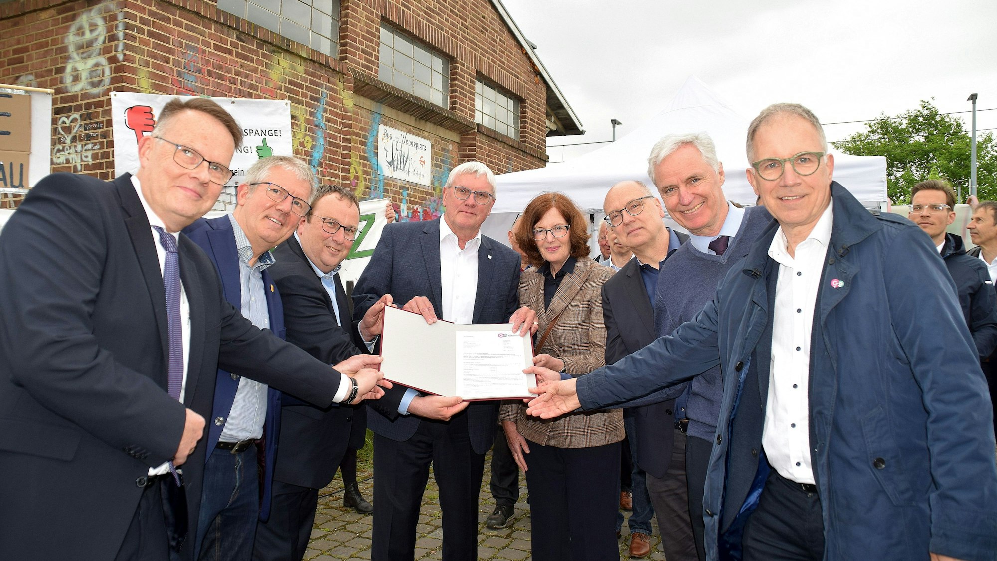 8. Mai 2023 Bornheim-Merten. Am Mertener Haltepunkt der Linie 18 übrgab Minister Oliver Krischer (3. von links) den Förderbescheid zum zweigleisigen Ausbau (von links), Jens-Albert Oppel (HGK), Christoph Becker (Bürgermeister Bornheim), Landrat Sebastian Schuster, Pia Regh (stellvertretende Bürgermeisterin Brühl). Helmut Wiesner (Stadtbaurat Bonn), Rolf Schumacher (Bürgermeister Alfter) und Norbert Reinkober (go.Rheinland). Foto: Frank Engel-Strebel