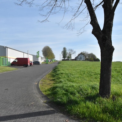 Eine Gewerbehalle und ein Stück Ackerland.