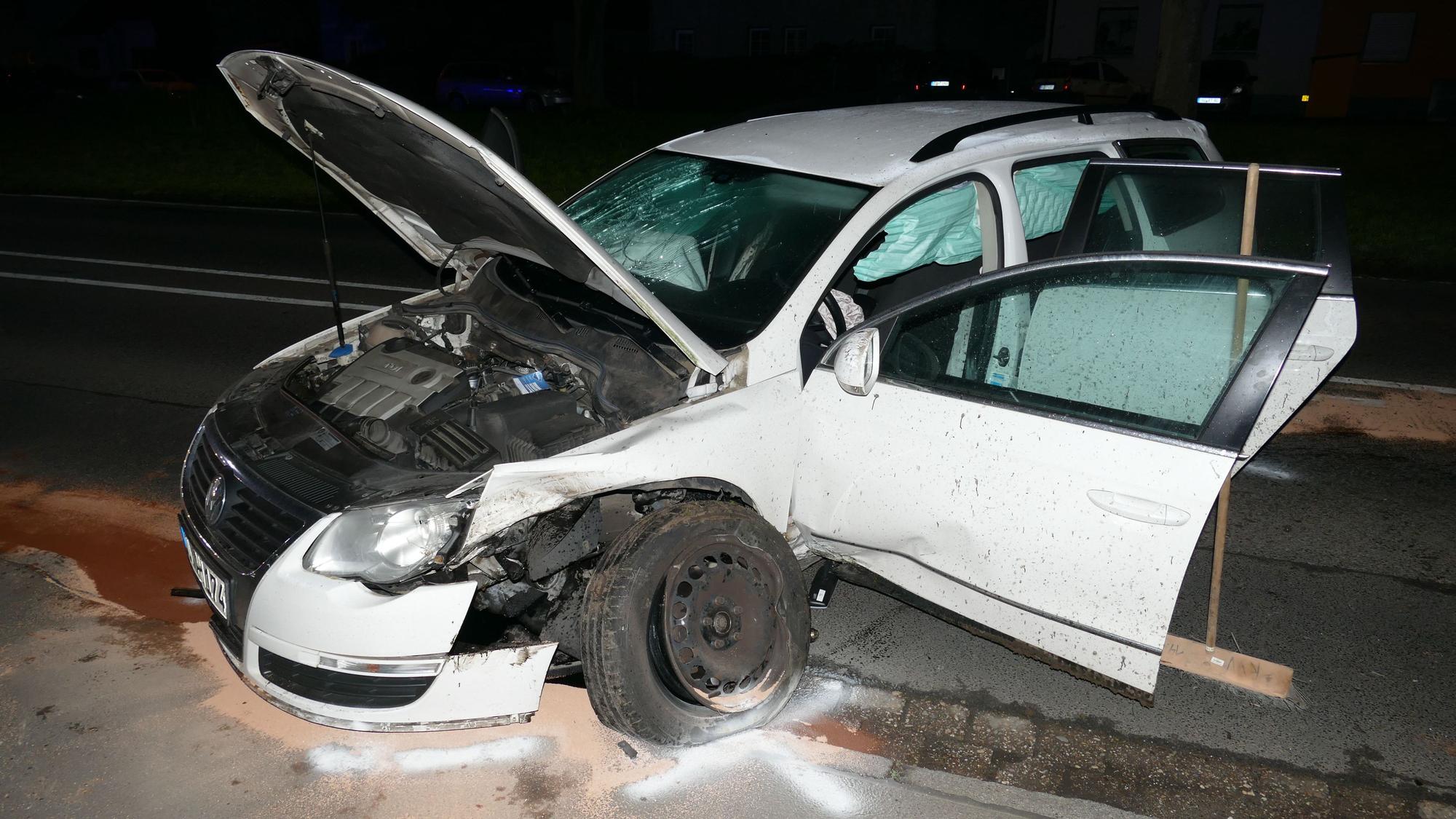 Das Auto steht schräg auf der Straße, alle Türen sind offen, Scheiben sind zerschlagen, die Reifen geplatzt. Unter dem Wagen ist Sand gestreut.