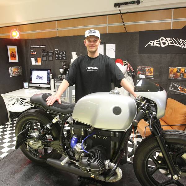Es ist Noel Hoffmann mit seinem Motorrad zu sehen. Er schaut in die Kamera.