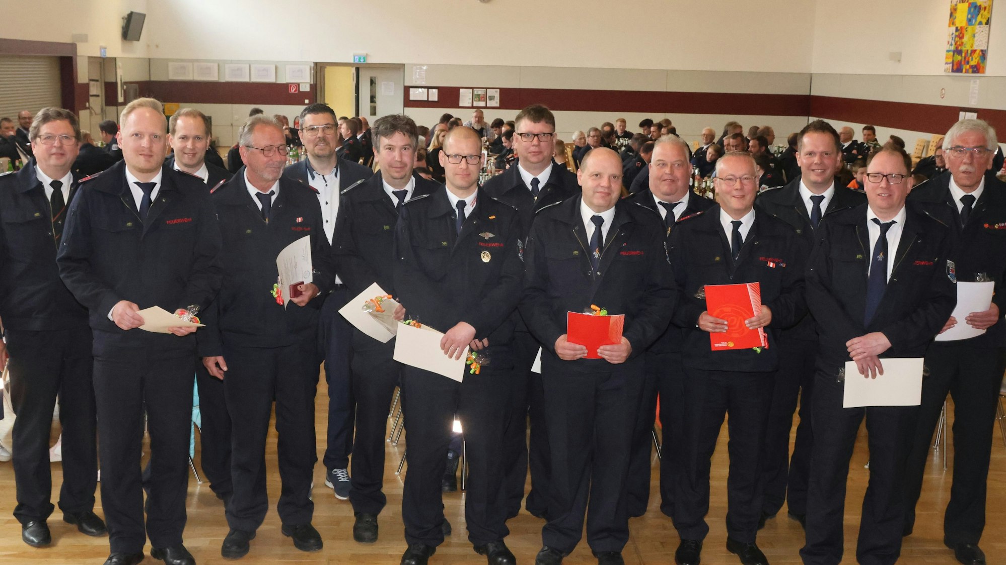 Zu sehen ist eine Gruppe von Feuerwehrleuten, die geehrt wurde.