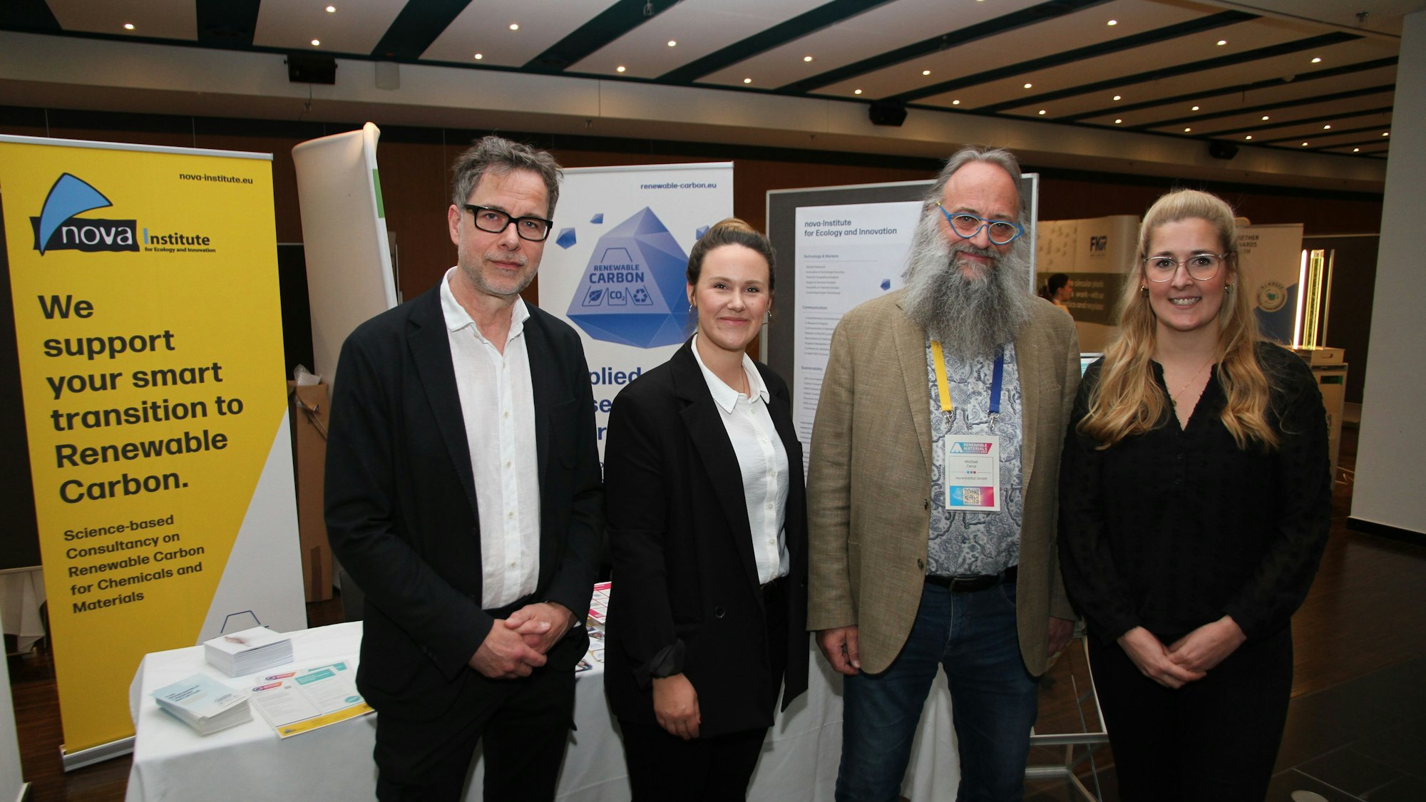 Zwei Frauen und zwei Männer stehen nebeneinander und blicken in die Kamera.