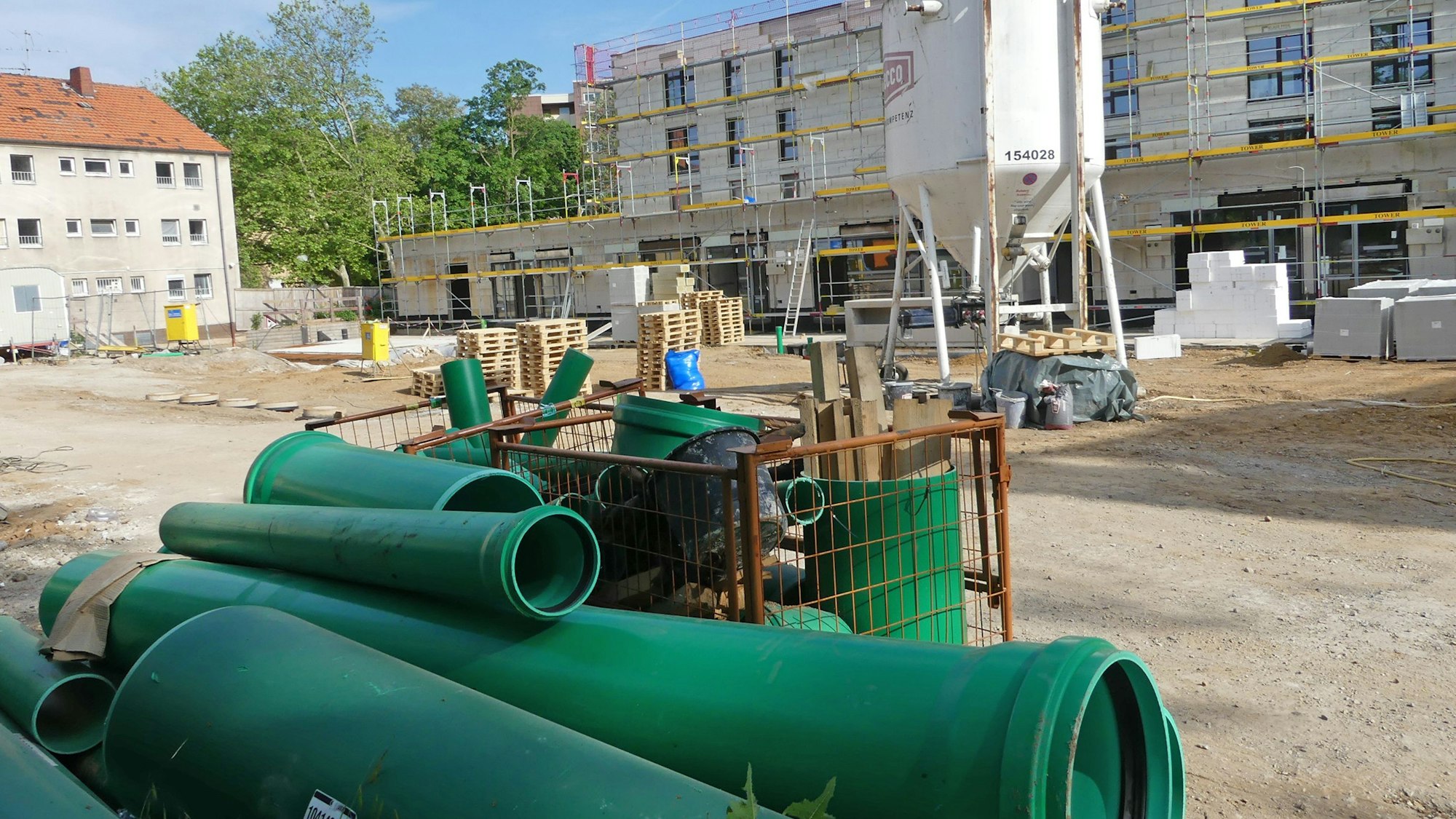 Eine Baustelle mit Rohren und Gerüst.