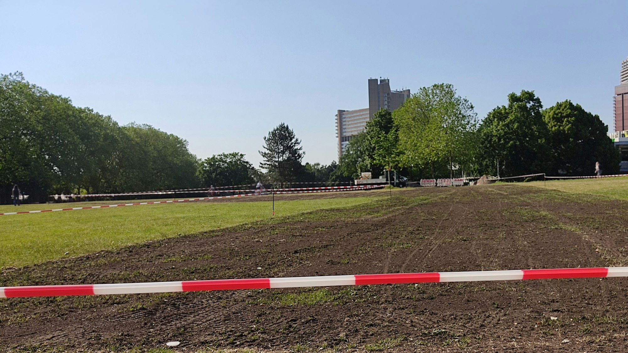 Die Uniwiese ist mit Absperrband abgesperrt. An einem Teil der Wiese ist nur noch der Boden zu sehen.