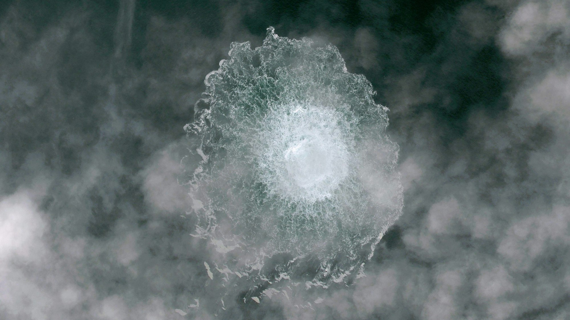 TOPSHOT - This handout picture taken and released on September 29, 2022 shows the release of gas emanating from a leak on the Nord Stream 2 gas pipeline, in the Swedish economic zone in the Baltic Sea. - A fourth leak has been detected in undersea gas pipelines linking Russia to Europe, the Swedish Coast Guard said on September 29, 2022, after explosions were reported earlier this week in suspected sabotage. (Photo by Handout / Airbus DS 2022 / AFP) / RESTRICTED TO EDITORIAL USE - MANDATORY CREDIT "AFP PHOTO / - / AIRBUS DS 2022 " - NO MARKETING NO ADVERTISING CAMPAIGNS - DISTRIBUTED AS A SERVICE TO CLIENTS