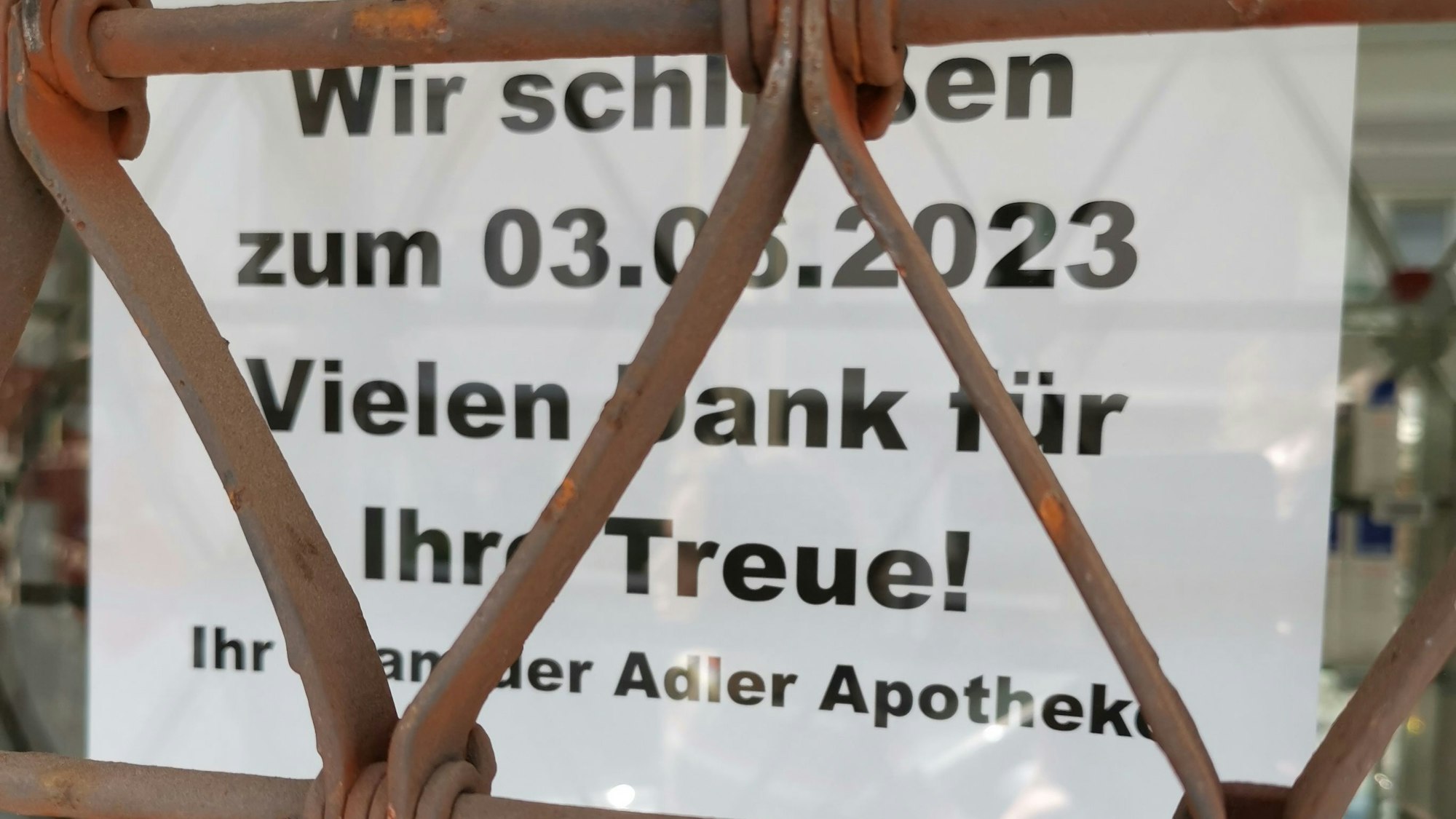 Ein Schild im Fenster weist auf die dauerhafte Schließung der Adler Apotheke Rheinbach hin.