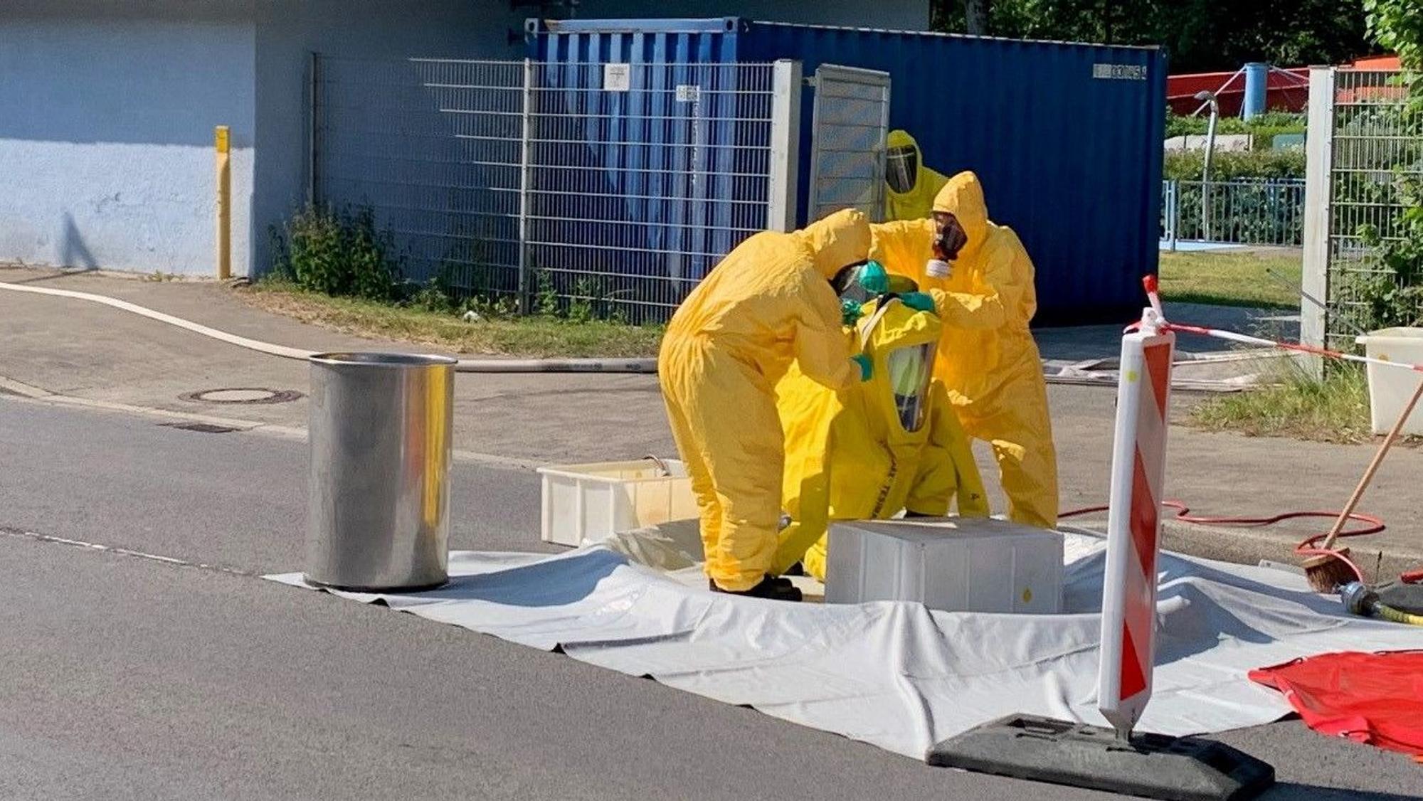 Mehrere Männer in gelben Uniformen sind bei einem Chlorgasaustritt in Einsatz.