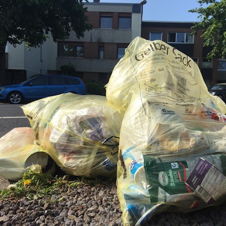 Auf dem Foto sind Gelbe Säcke am Straßenrand zu sehen.