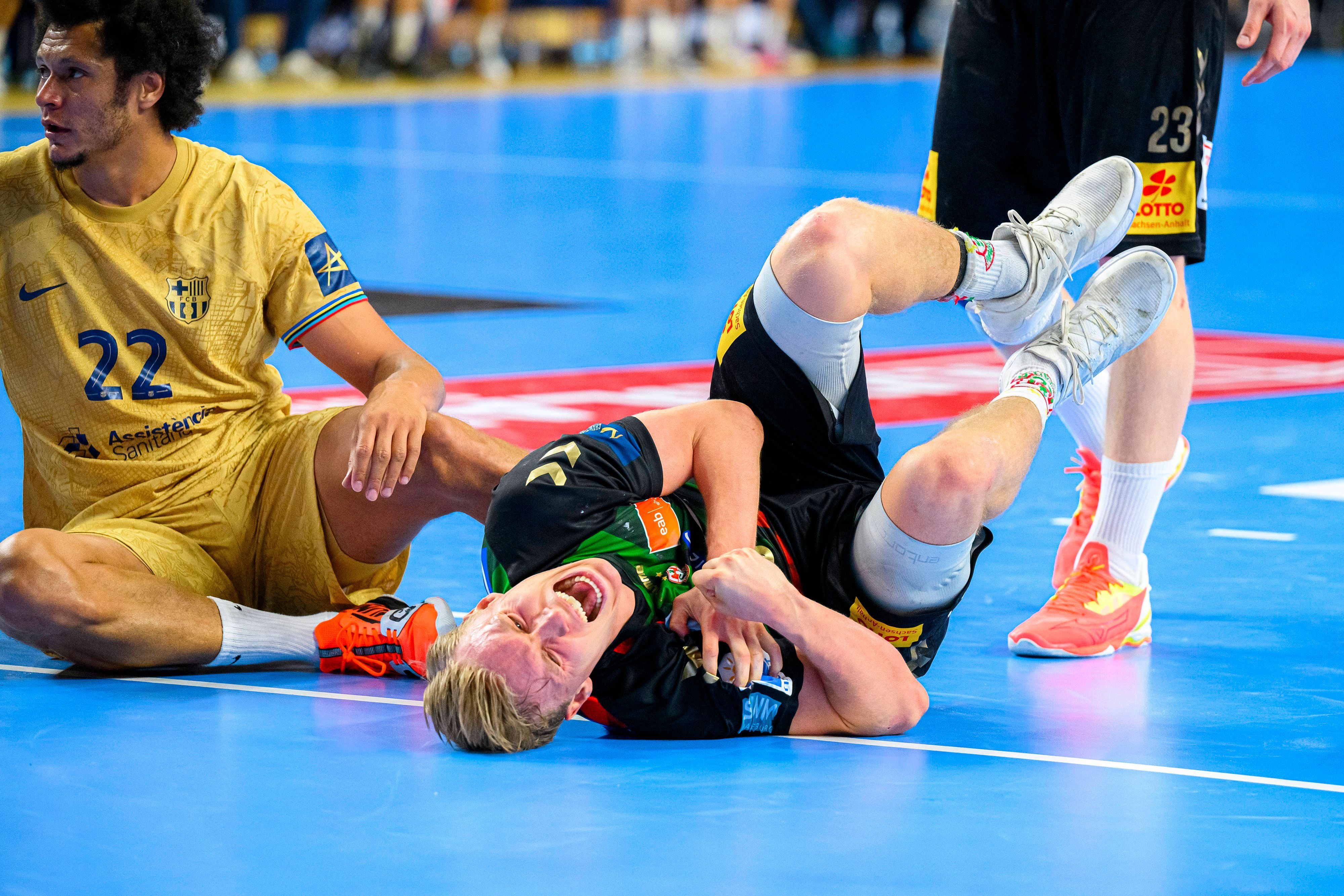 Gisli Thorgeir Kristjansson vom SC Magdeburg liegt mit Schmerzen verletzt auf dem Hallenboden