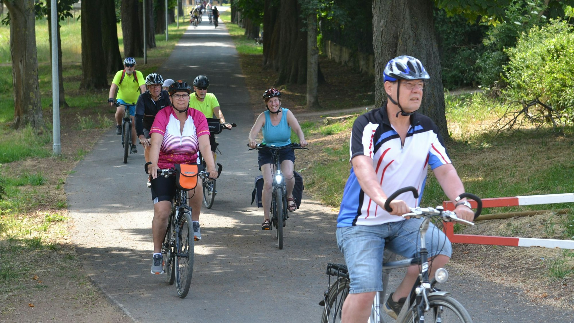 Mehrere Radfahrer radeln durch den Erftpark in Euskirchen.