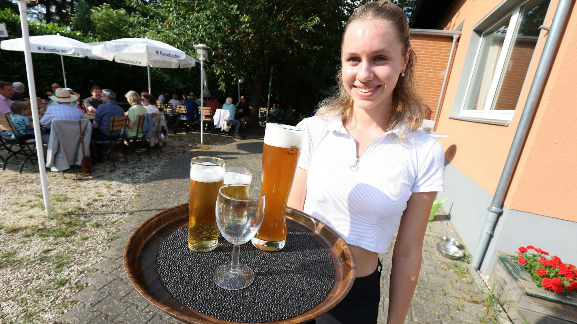 Louisa Schimmel beim Servieren im Biergarten des Restaurants Waldesruh in Wachtberg-Villiprott.