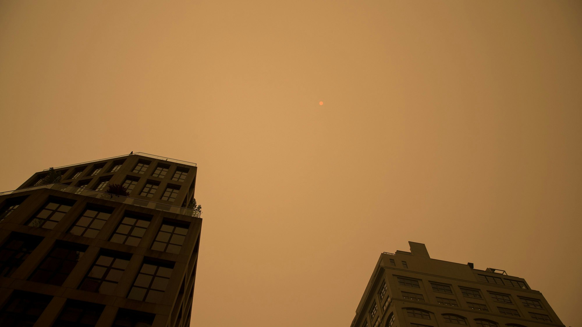 Eine dichte Rauchwolke hängt über der US-Metropole New York. Der Himmel ist gelblich gefärbt, die Sicht ist schlecht.