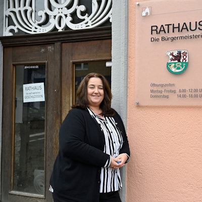 Bondina Schulze steht vor einem Rathausschild.