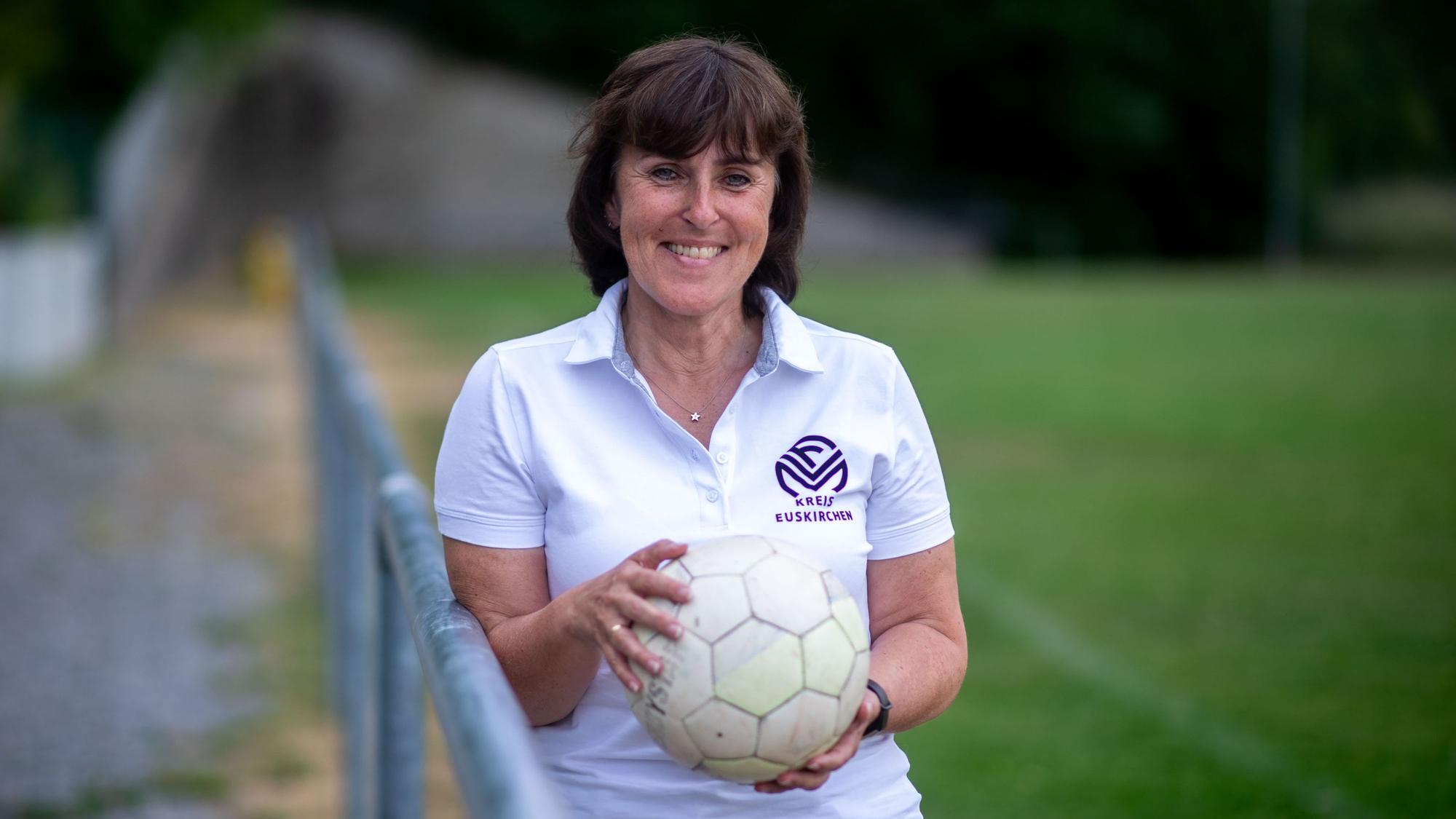 Doris Mager lehnt an eine Absperrstange und hält einen Ball in ihren Händen.