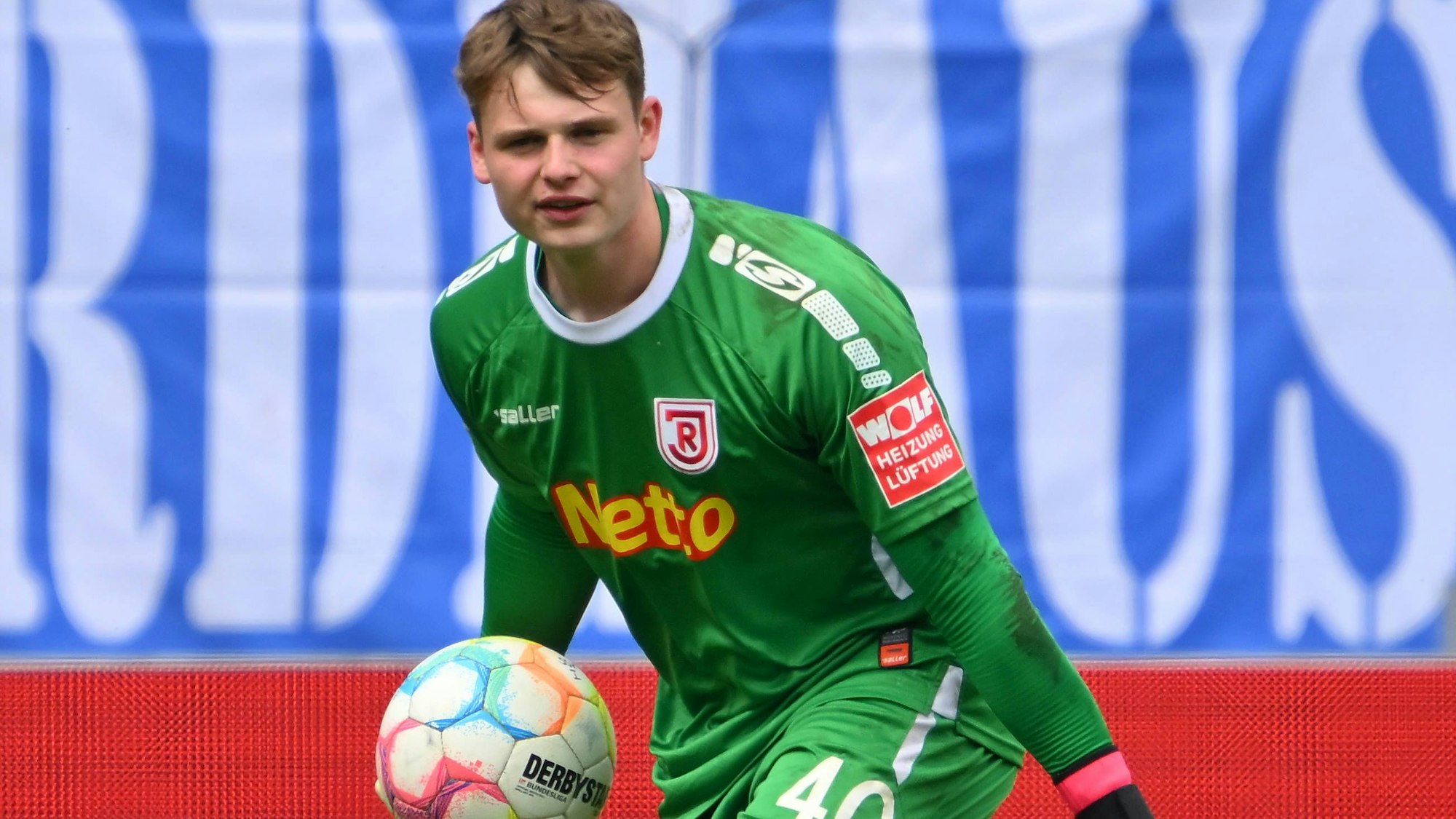 Jonas Urbig hält einen Ball in der Hand.