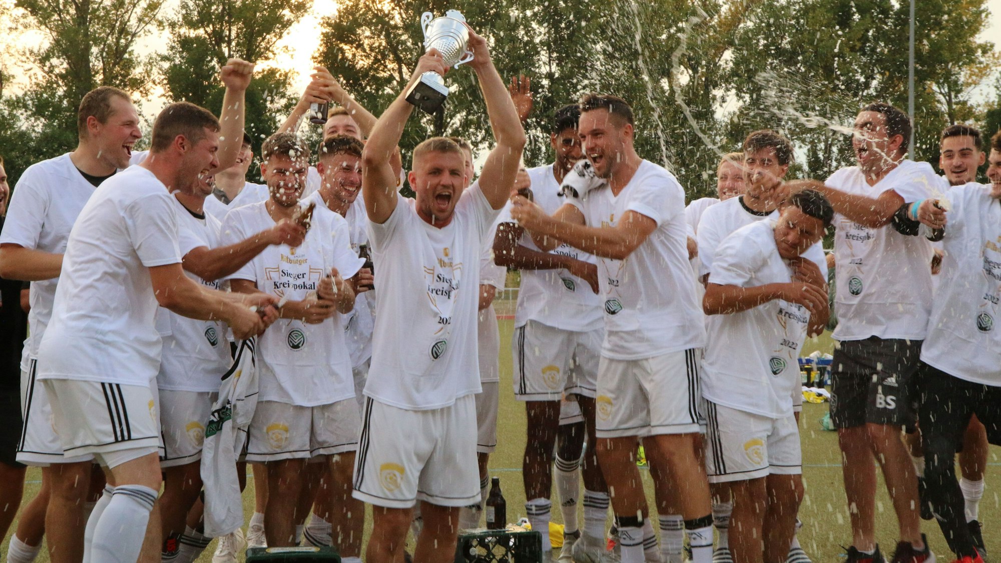 Die Spieler des SC Germania Erftstadt-Lechenich jubeln nach dem Sieg im Endspiel und recken den Pokal in die Höhe.