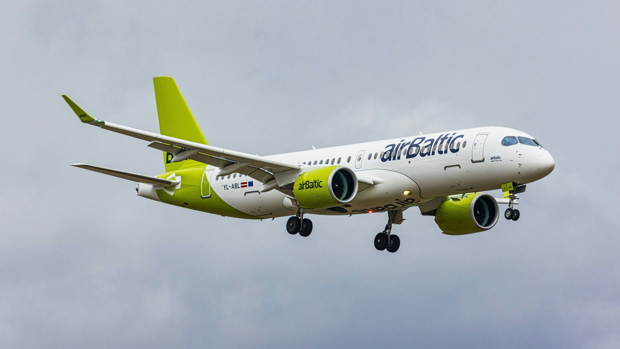 Ein Airbus der Gesellschaft Air Baltic (A220-300) im Landeanflug. Eine Passagiermaschine, die auf dem Weg nach Riga war, musste nach einem Blitzeinschlag nach Hamburg umdrehen.
