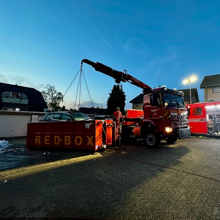Die Einsatzstelle im Stadtteil Moitzfeld von Bergisch Gladbach. Das Auto wird in einen Container gehoben.