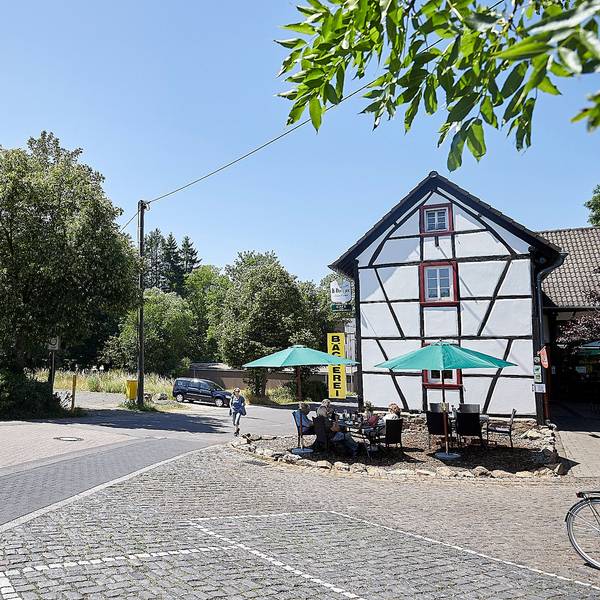 Auf dem Bild ist links das Café zur Römerquelle zu sehen, rechts der Parkplatz, auf dem ein Neubau entstehen soll.