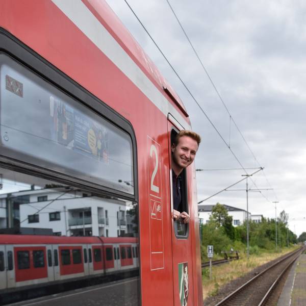 Ein Mann blickt aus dem Fenster eines Zuges.