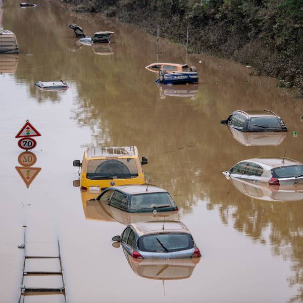 Autos stehen auf der überfluteten Bundesstraße 265 bei Erftstadt im Wasser.