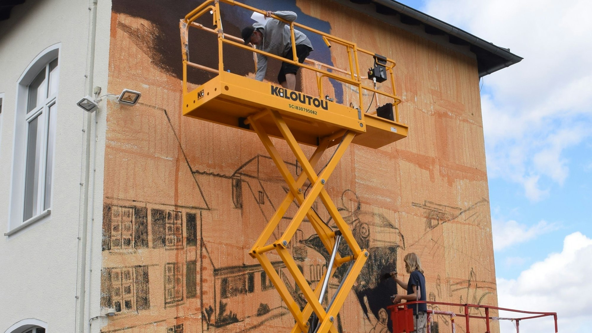 Die Künstler Case Maclaim (Andreas von Chrzanowski, oben) und Lukas Zimmermann (unten) bemalen die Außenwand der Swistbachschule mit ihrem Wandgemälde.