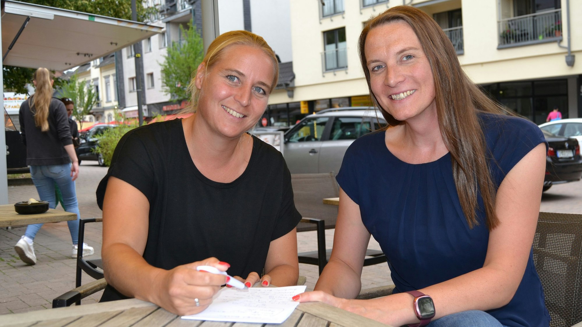 Diana Ufer und Sandra Müller aus Wiehl sitzen gemeinsam an einem Tisch, vor ihnen eine Liste.