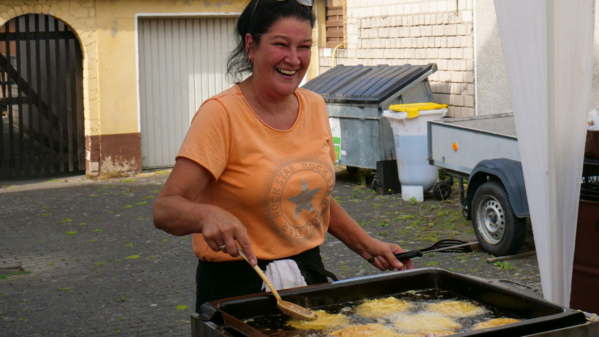 Auf dem Foto ist zu sehen, wie Michaela Quandt Reibekuchen zubereitet.