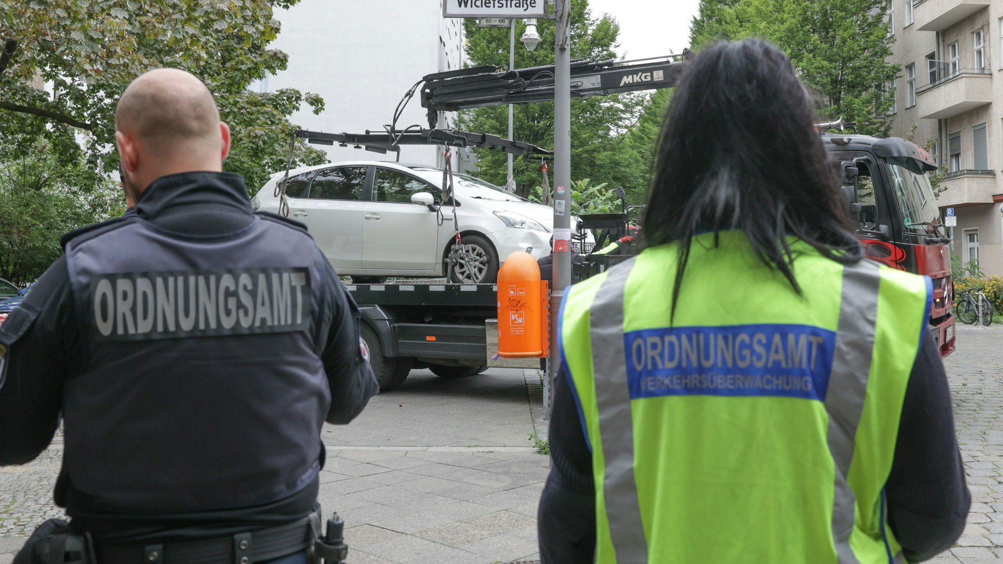 Mitarbeiter des Ordnungsamts lassen ein Fahrzeug abschleppen.