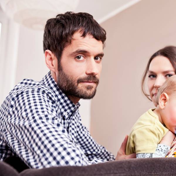Vater, Mutter und Kind blicken gestresst