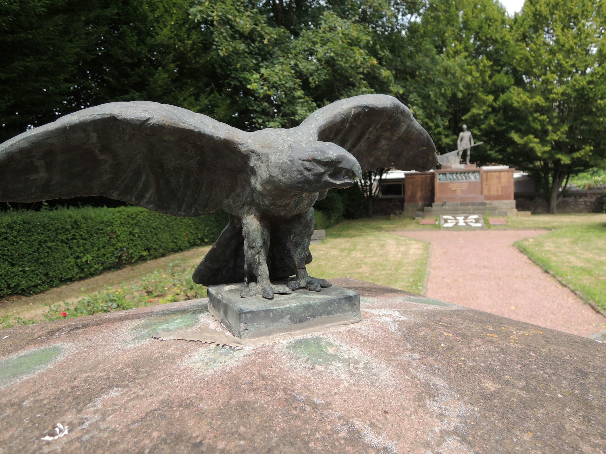Ein Adler aus Stein hat die Flügel ausgebreitet, es sieht aus, als würde er schreien.