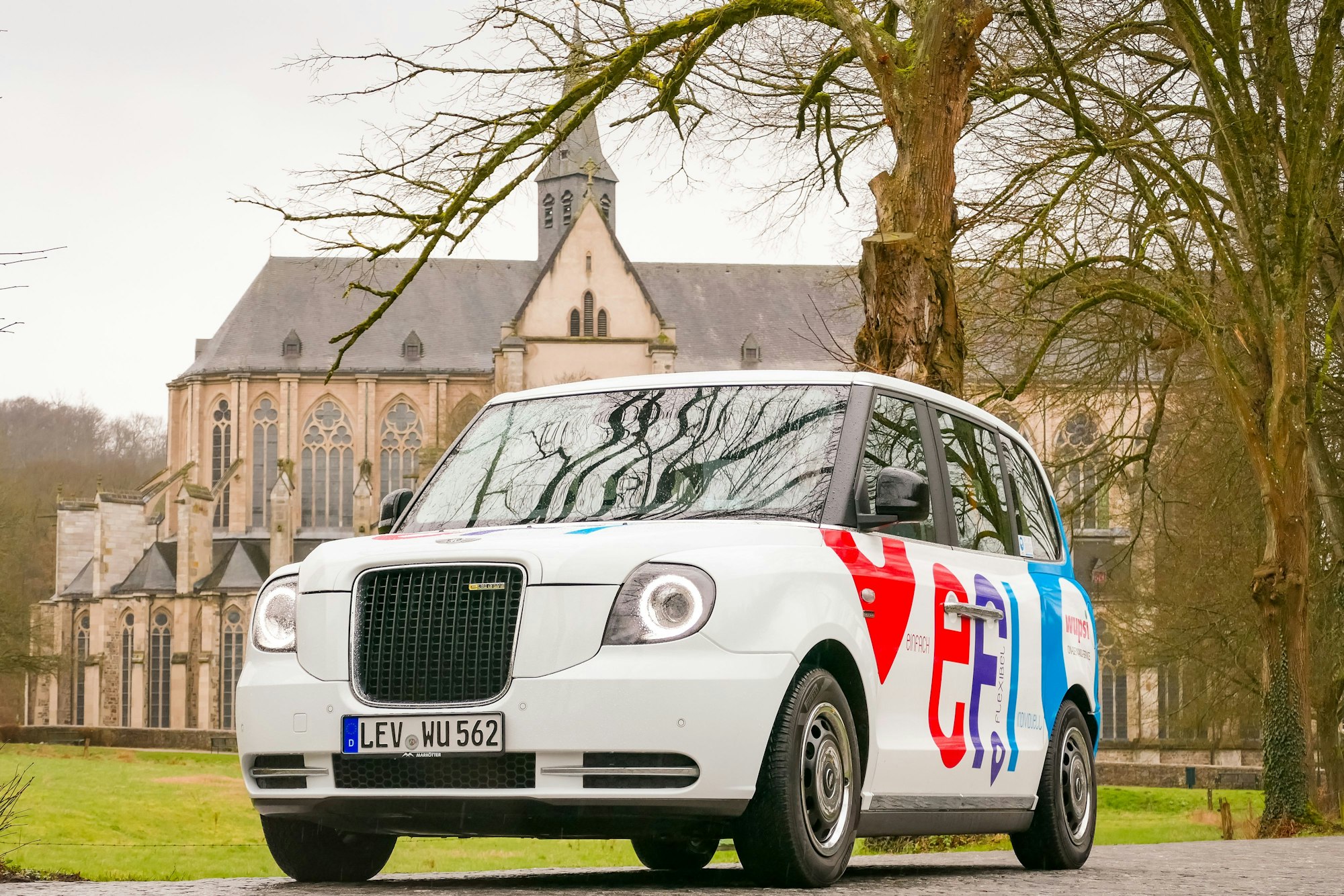 Das Foto zeigt das Auf-Abruf-Taxi Efi vor dem Altenberger Dom.
