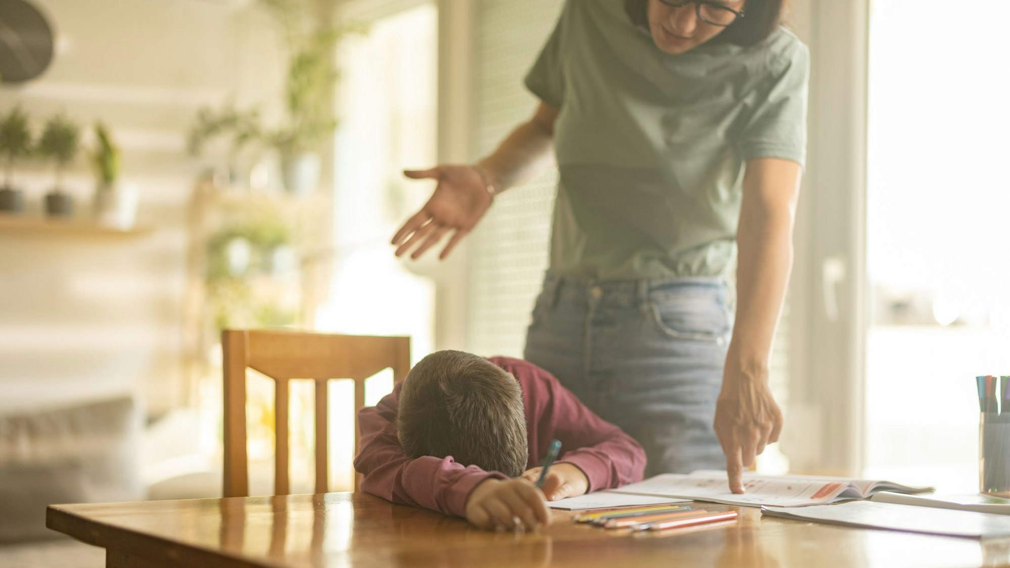 Eine Mutter streitet mit ihrem Sohn über die Hausaufgaben.