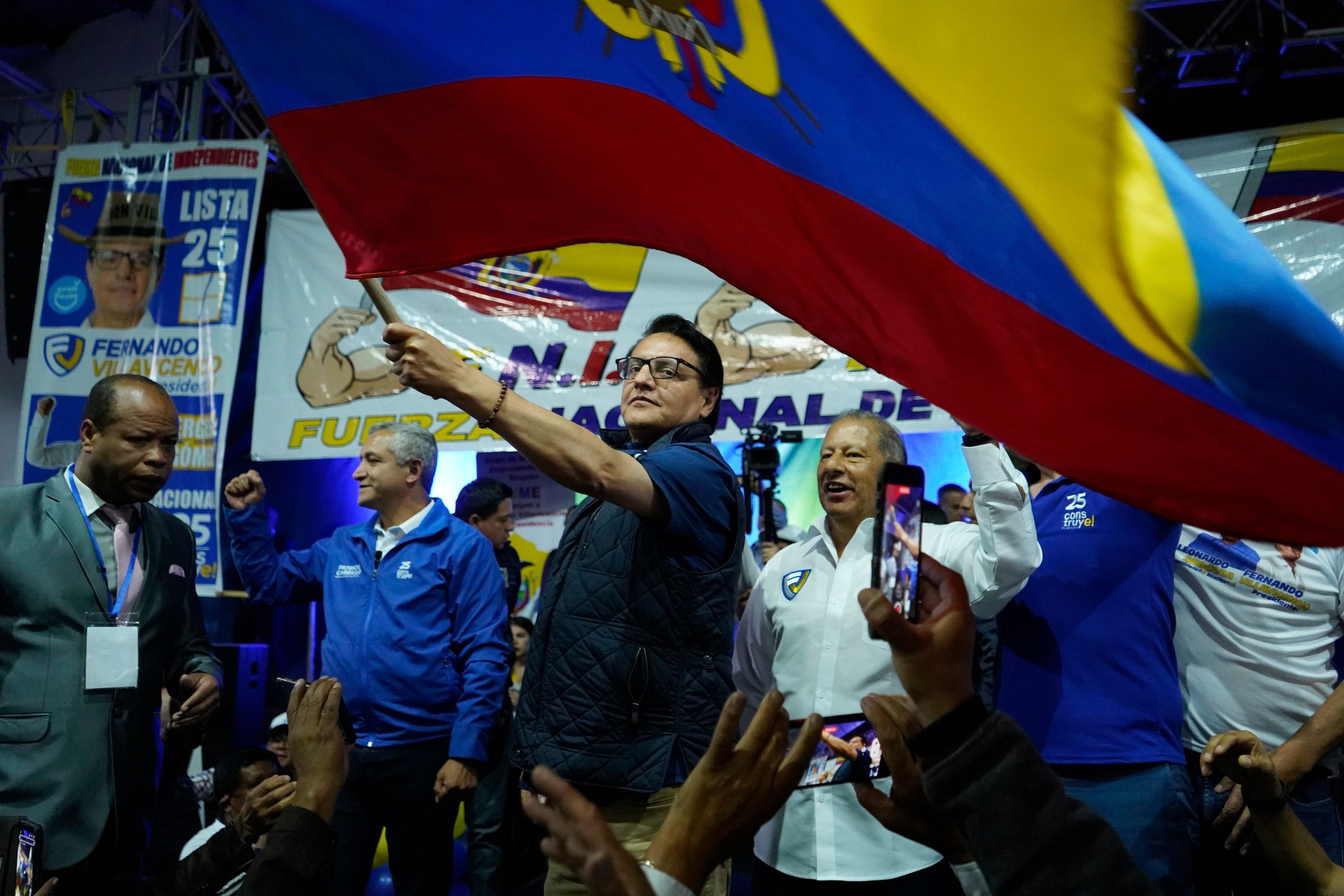 Der Präsidentschaftskandidat Fernando Villavicencio schwenkt eine Nationalflagge während einer Wahlkampfveranstaltung in einer Schule, nur wenige Minuten bevor er vor derselben Schule erschossen wurde, in Quito, Ecuador.