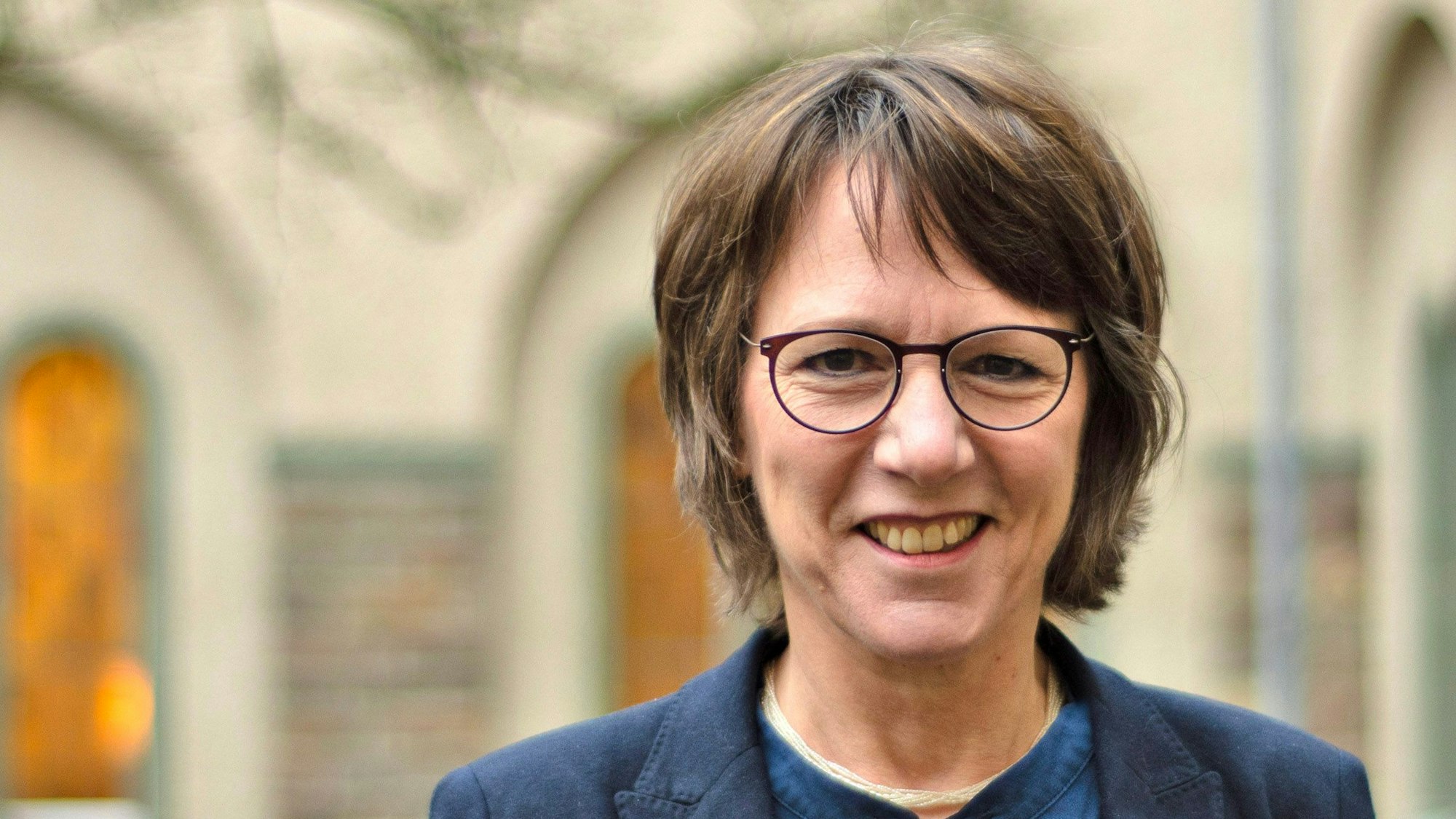 Eine Frau lächelt in die Kamera.