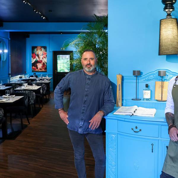 Luis Dias und Küchenchef Cyril Becker stehen in der neu eröffneten Weinbar vor einer türkisfarbigen Kommode.